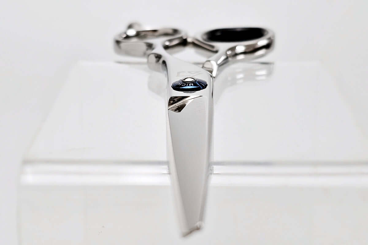 Silver scissors with a unique design on a white background