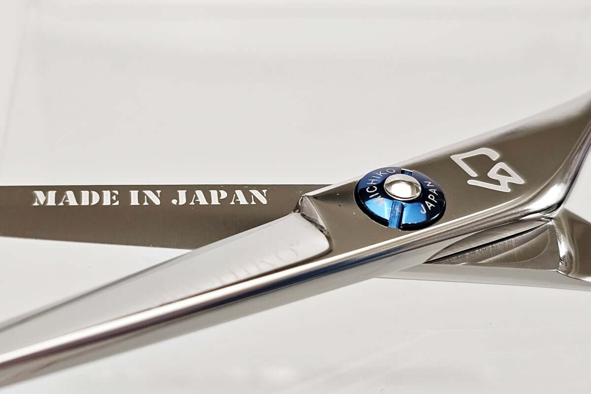 Close-up of a pair of hair scissors with 'Made in Japan' and 'MICHIKO' branding on a white background