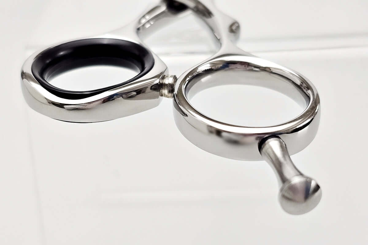 Close-up of hair scissors handle part on a white background
