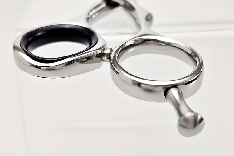 Close-up of hair scissors handle part on a white background