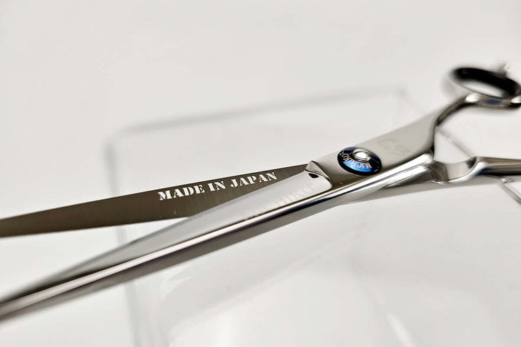 Pair of hair scissors with 'Made in Japan' engraving on a white background