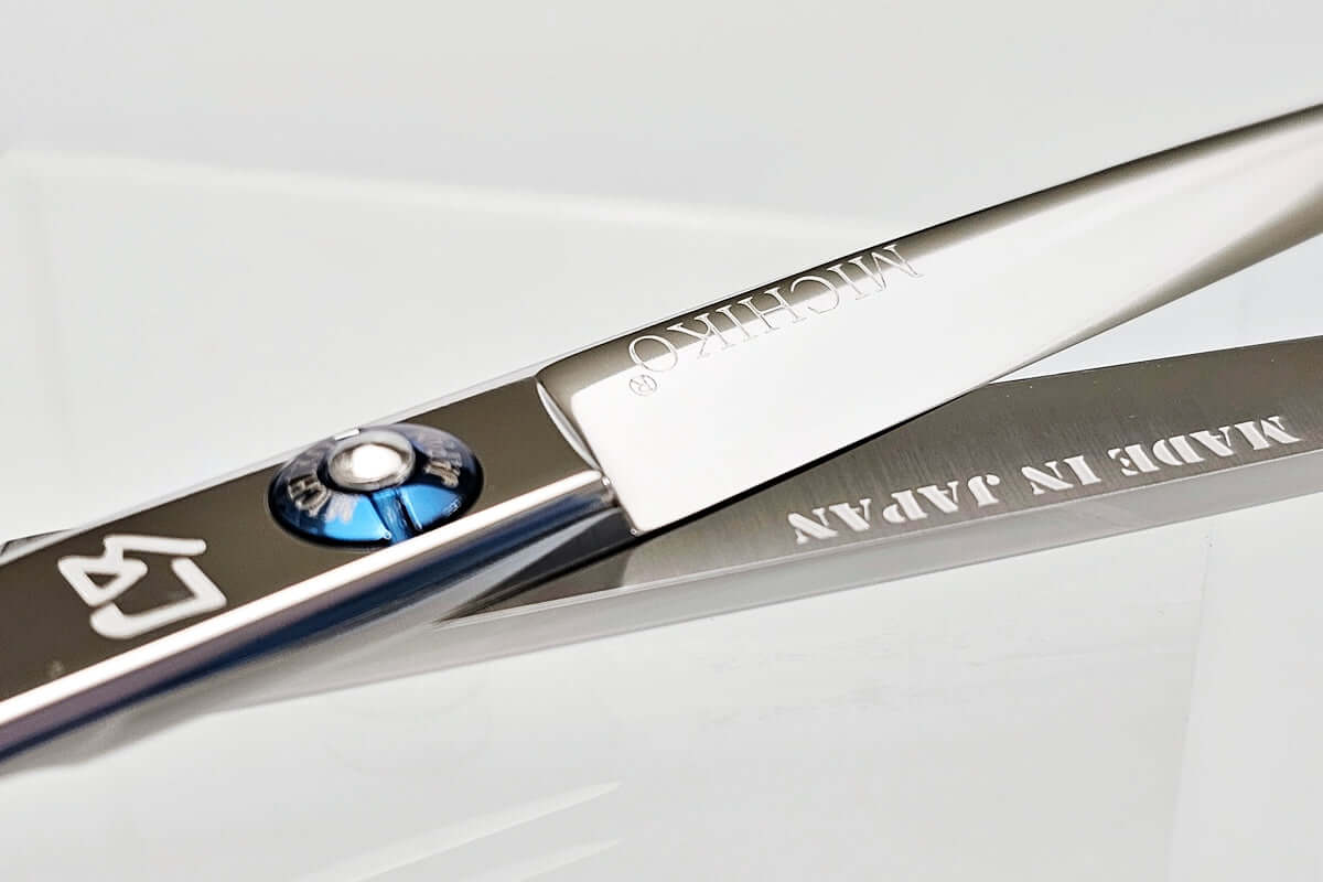 Close-up of hair scissors with 'MICHIKO' branding on a white background