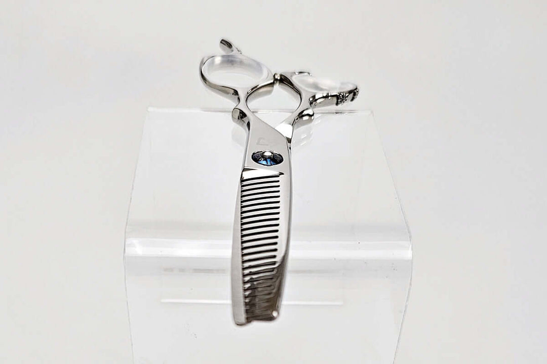 Hair thinning shears on a clear stand against a white background