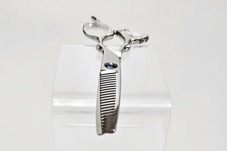 Hair thinning shears on a clear stand against a white background