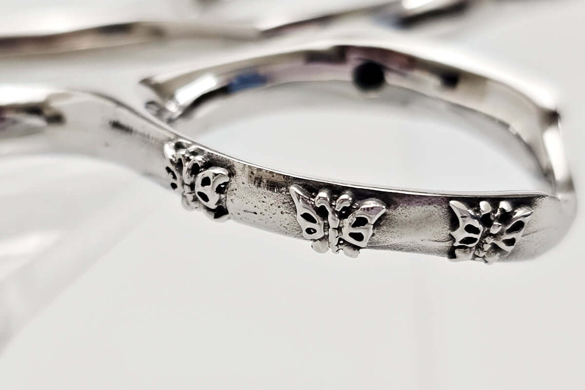 Close-up of hair scissors handle on a whtie background