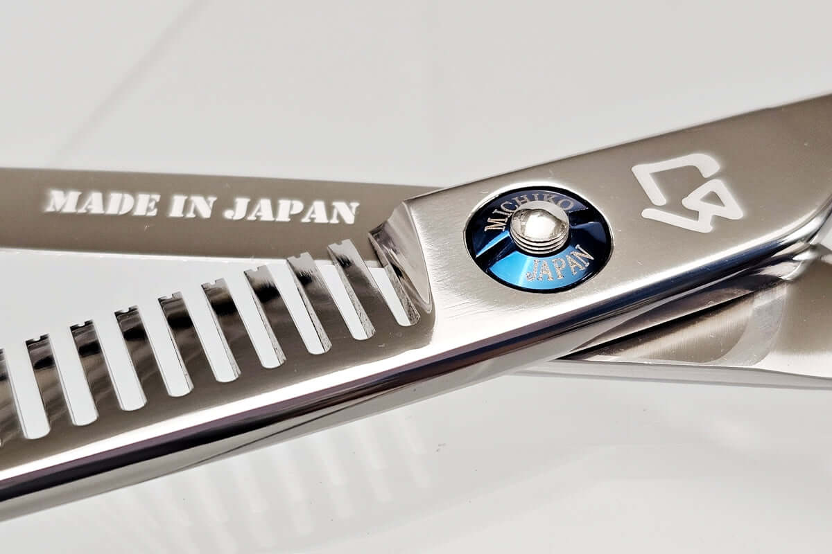 Close-up of hair thinning scissors with 'Made in Japan' written on the blade.