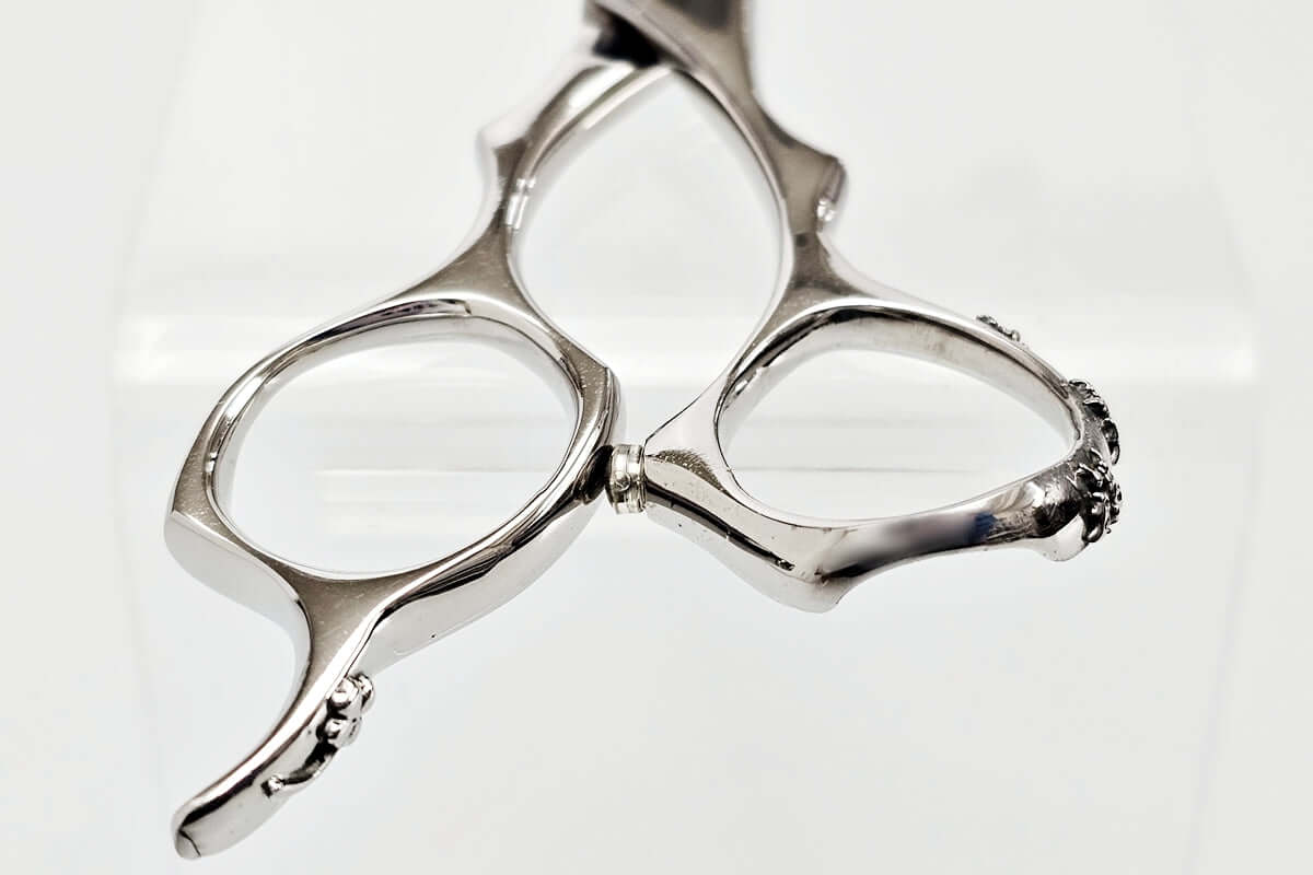 Close-up of hair scissors handle oon a whtie background