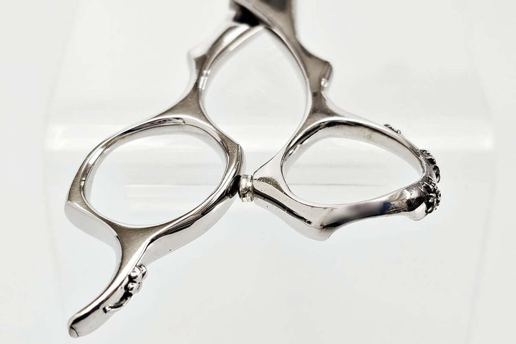 Close-up of hair scissors handle oon a whtie background
