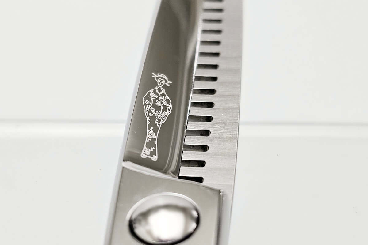 Close-up of a pair of thinning scissors with a logo on a white background