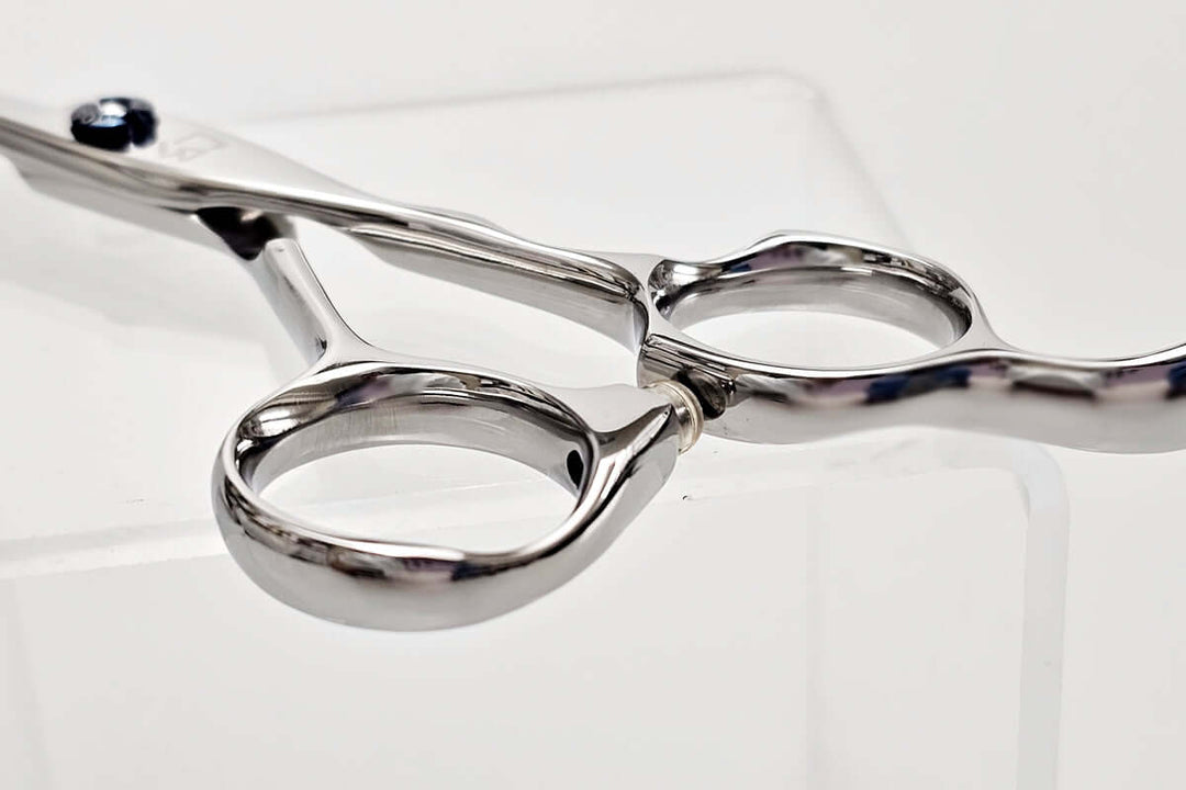 Close-up of a pair of hair scissors on a white background