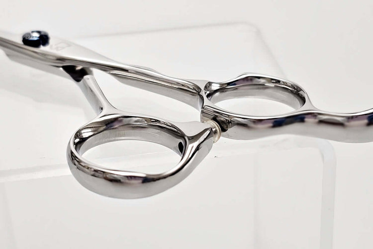 Close-up of a pair of hair scissors on a white background
