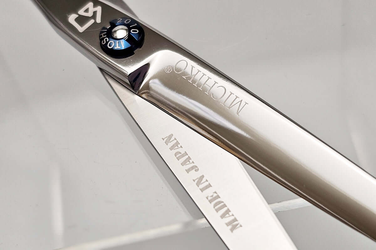 Close-up of a Michiko scissors with 'Made in Japan' engraving on a clear background