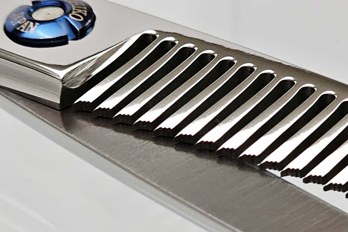 Close-up of hair thinning scissors teeth part on a light gray background