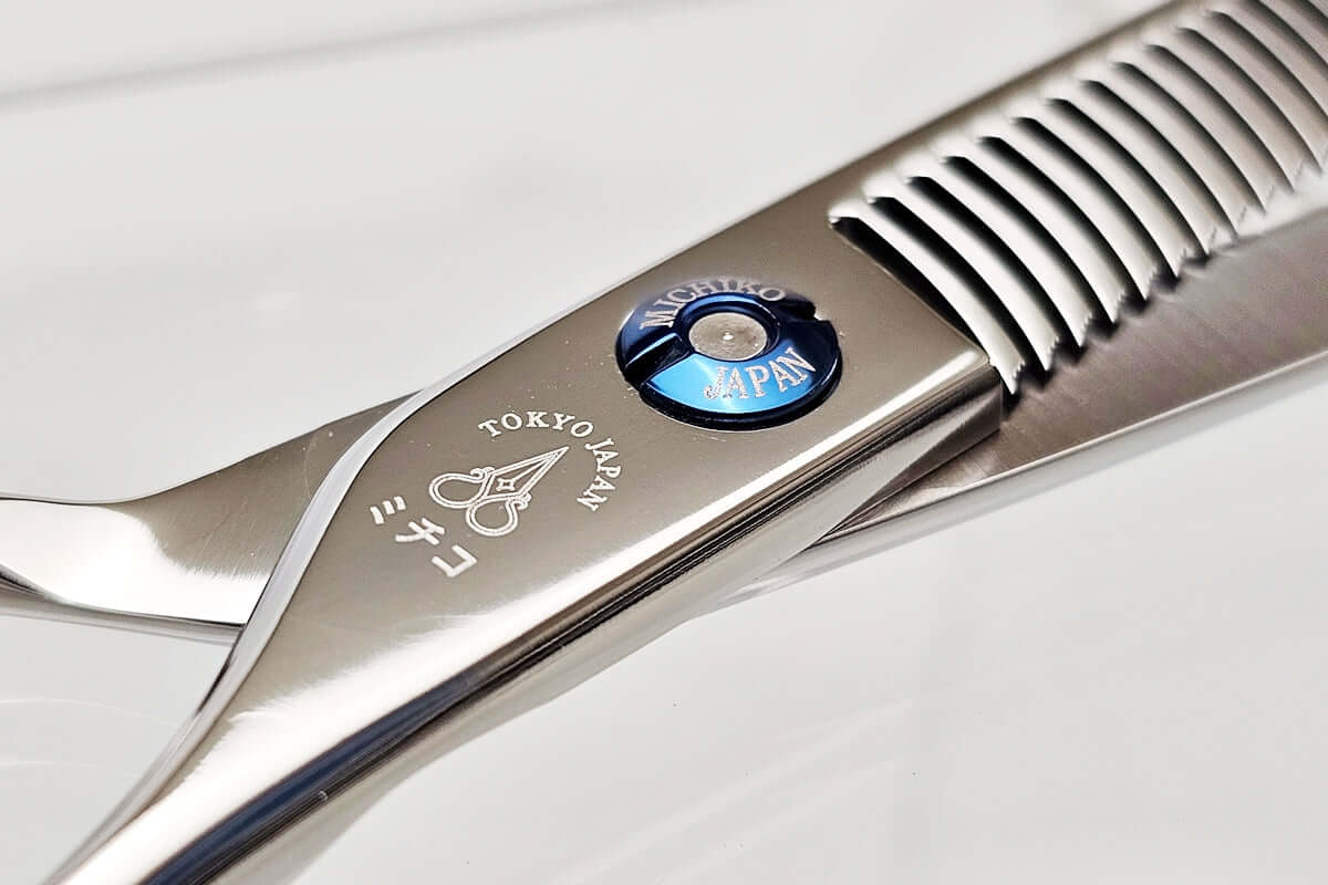 Close-up of hair thinning scissors teeth part on a light gray background