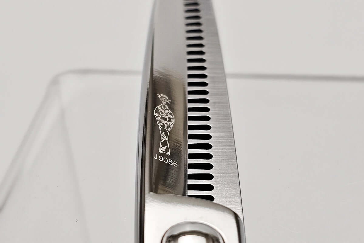 Close-up of a pair of hair scissors with a brand logo on a white background