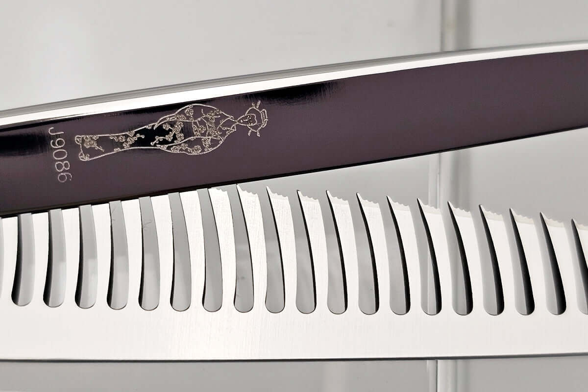 Close-up of hair thinning scissors blade with engraved MICHIKO lady logo on a white background