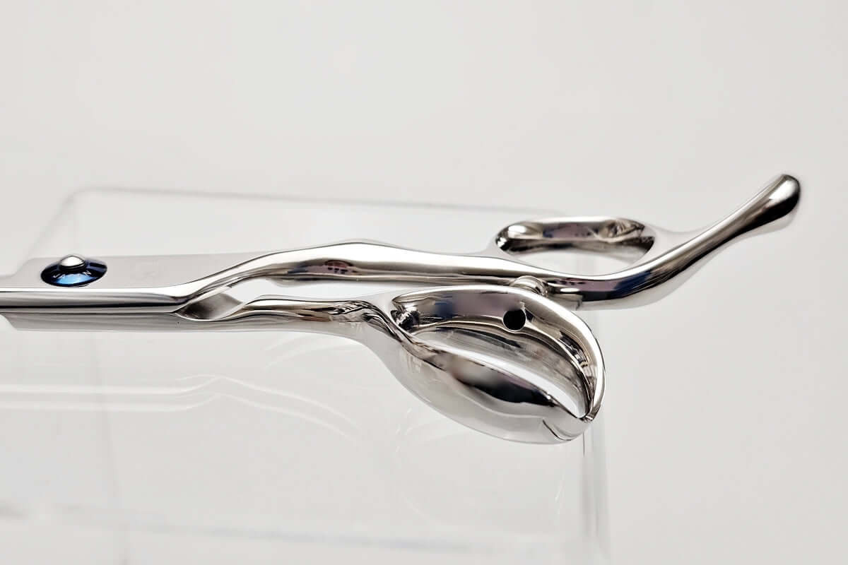 Close-up of hair scissors handle on a white background