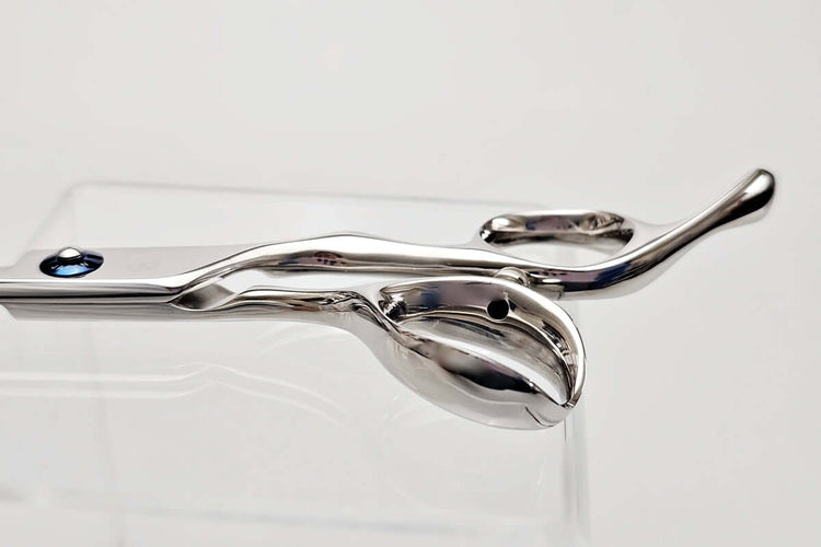 Close-up of hair scissors handle on a white background
