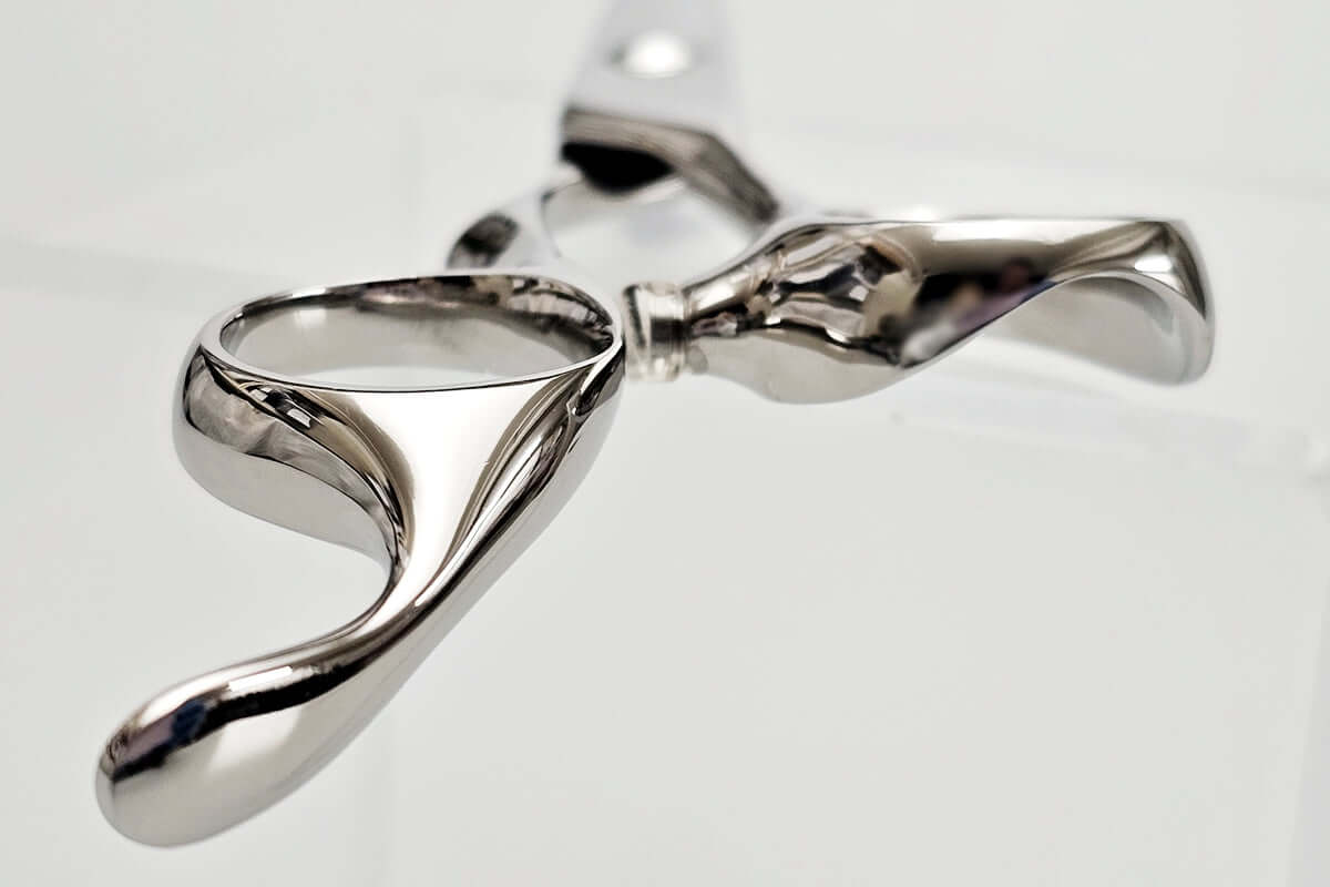 Hair scissor handle with a unique design on a light gray background