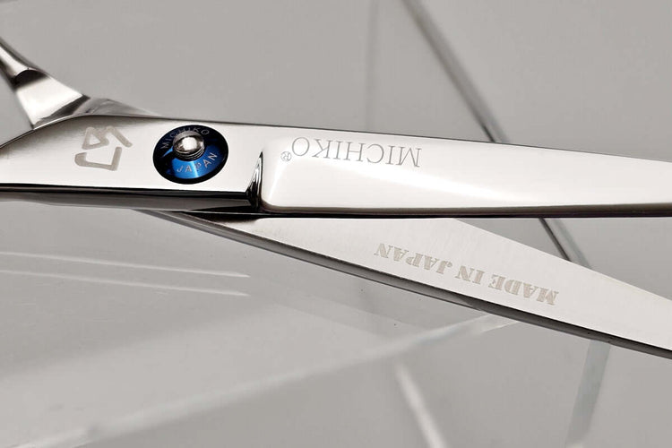 Close-up of a pair of Michiko scissors with 'Made in Japan' text on a gray background