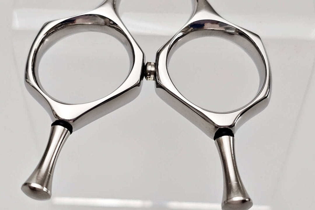 Close-up of a pair of hair scissors handle on a white background