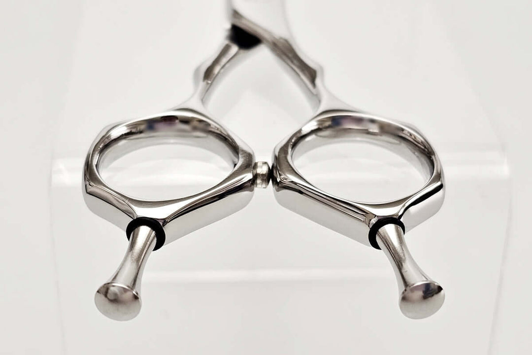 Close-up of hair scissors handle on a white background