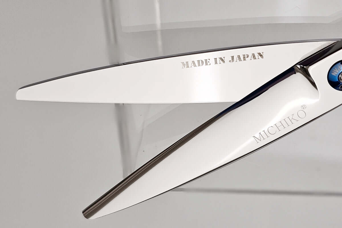 Sharp hair scissor blades with 'Made in Japan' and 'Michiko' branding on a clear background