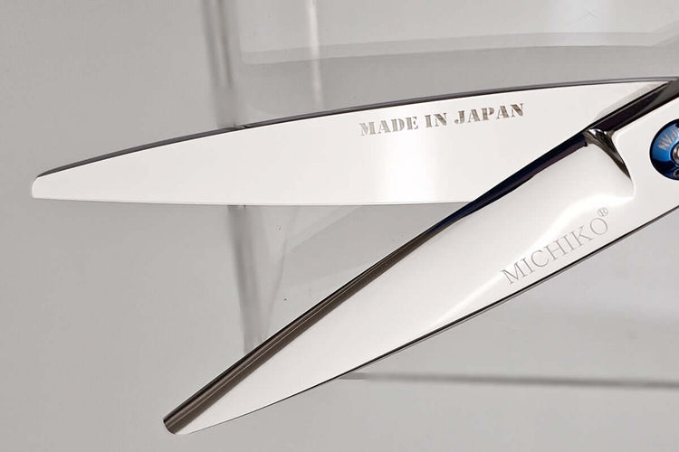 Sharp hair scissor blades with 'Made in Japan' and 'Michiko' branding on a clear background