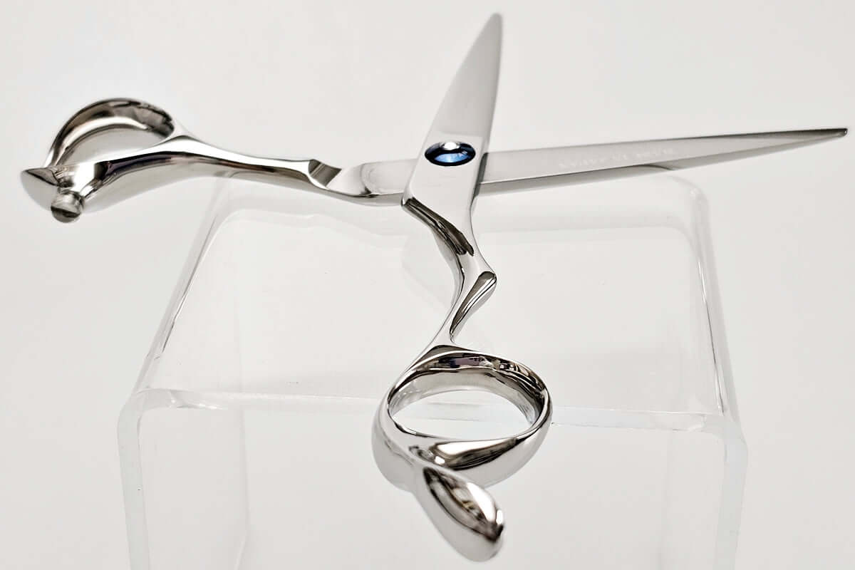 Silver hair scissors on a white background