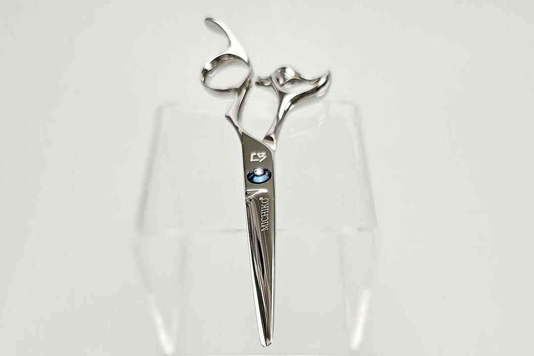 Hair cutting shears with a brand logo on a white background
