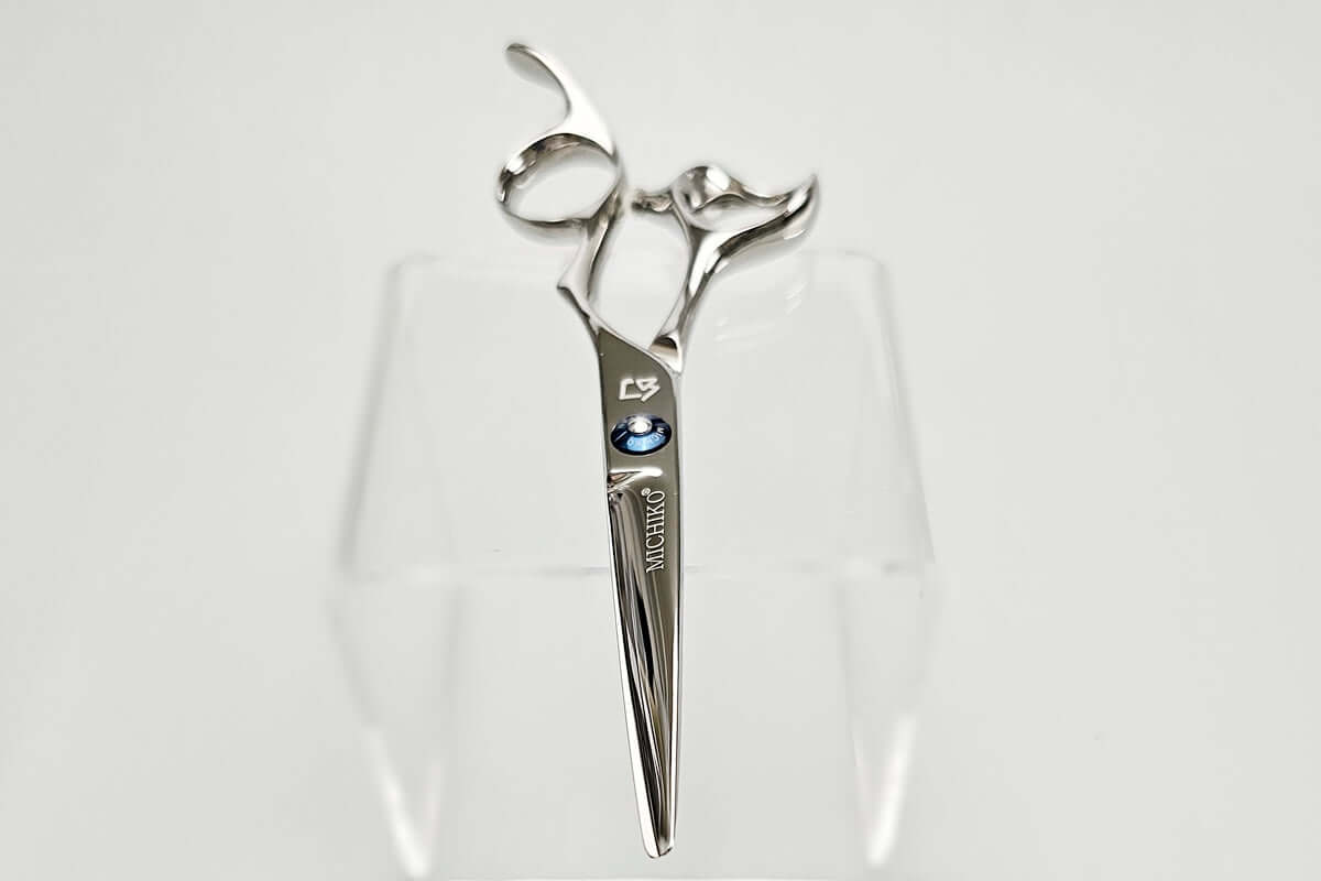 Hair cutting shears with a brand logo on a white background