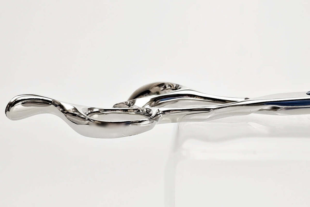 Close-up of hair scissors handle part on a light gray background