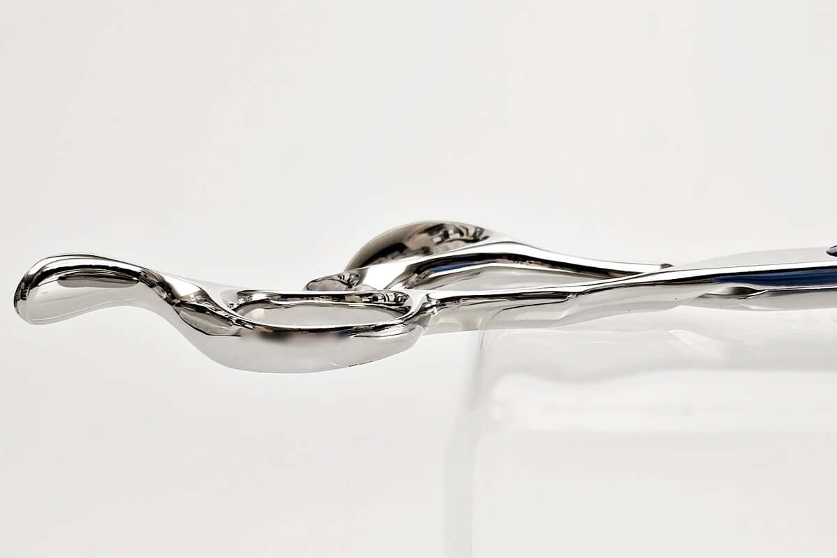 Close-up of hair scissors handle part on a light gray background