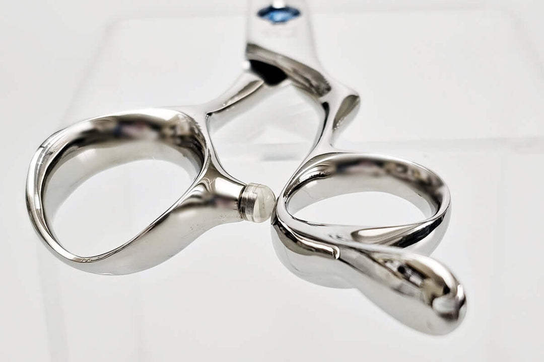 Close-up of hair scissors handle on a white background