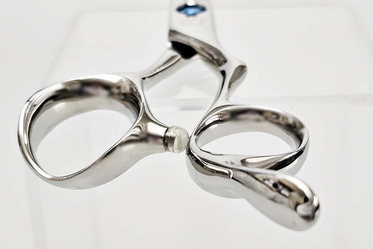 Close-up of hair scissors handle on a white background