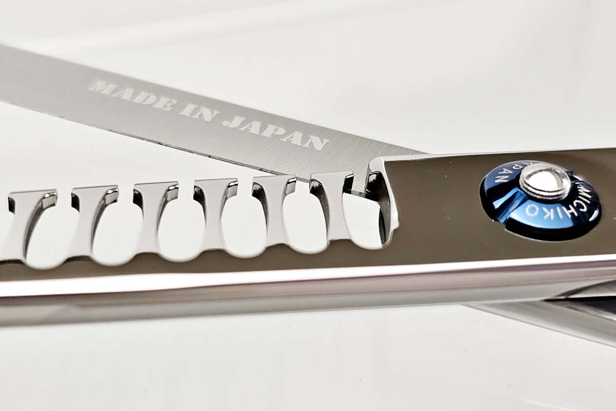 Close-up of hair texturizing shears with 'Made in Japan' text on a white background