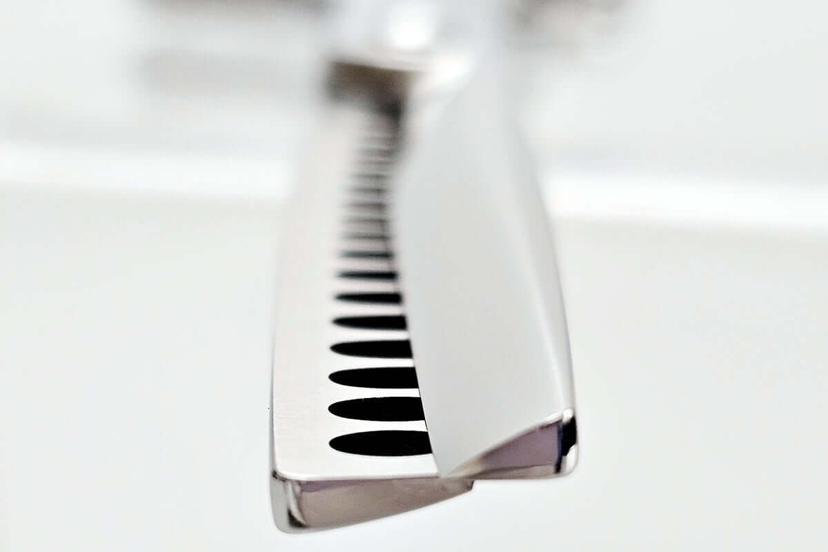 Close-up of hair texturizing shears on a white background