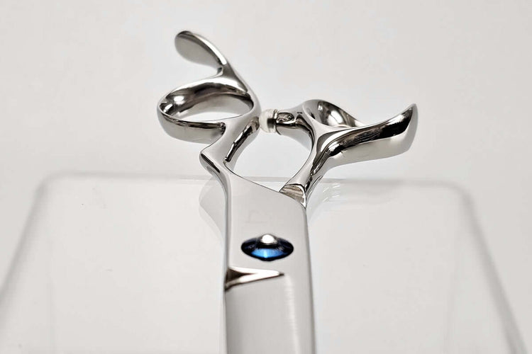 Close-up of hair scissors handle part on a white background