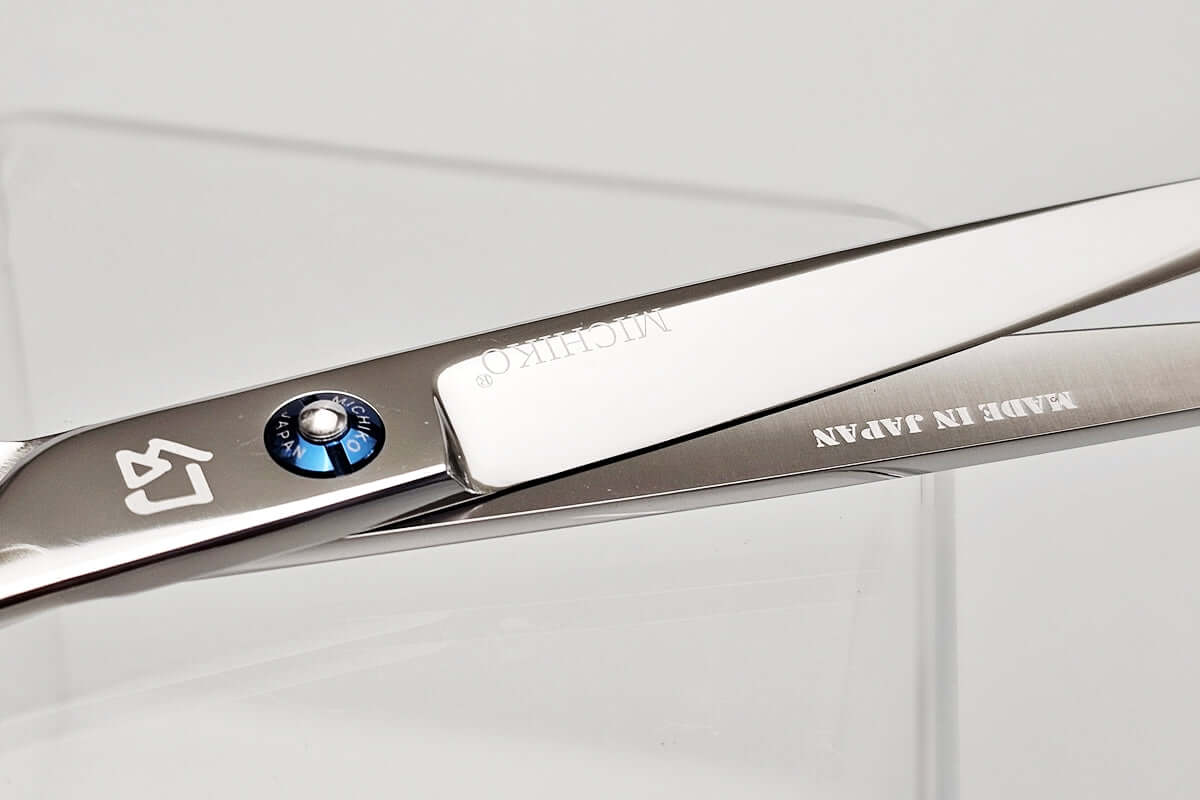 Hair scissors with MICHIKO brand logo on a light gray background