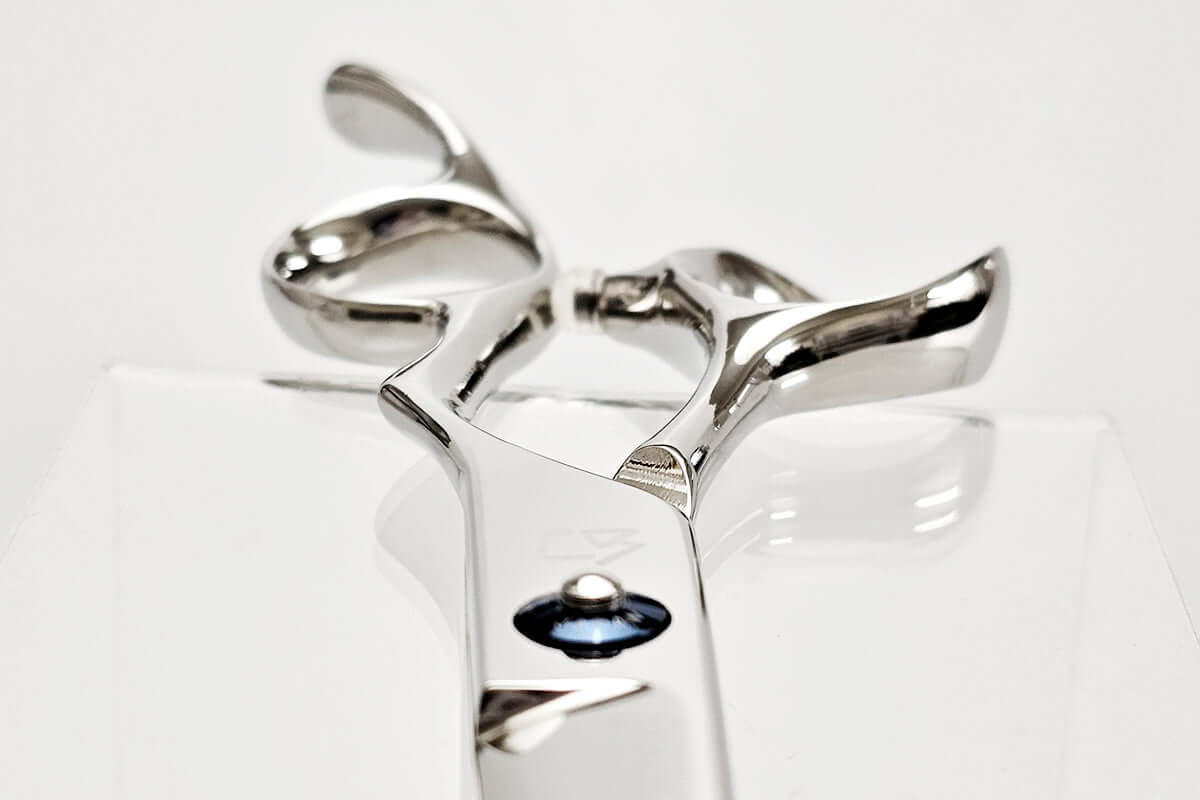 Close-up of hair scissors handle on a white background