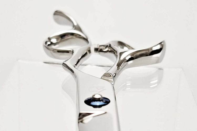 Close-up of hair scissors handle on a white background