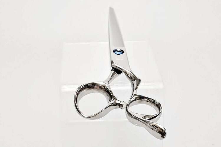 Silver scissors on a white background