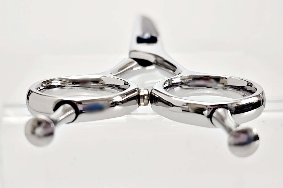 Close-up of thinning shears on a white background