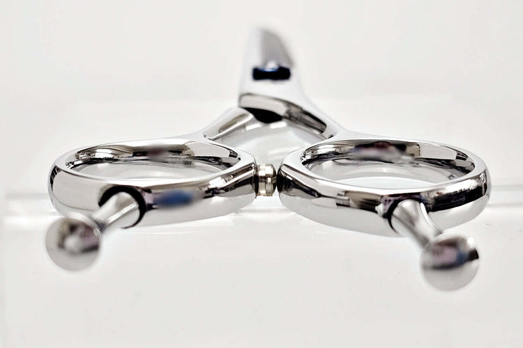Close-up of thinning shears on a white background